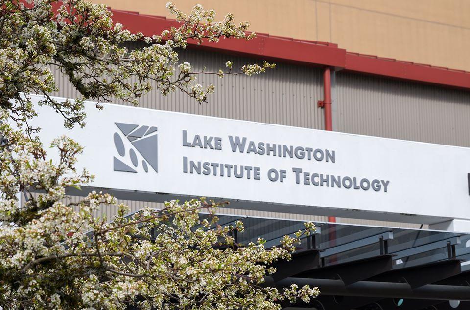 Outside of a building, a sign reads Lake Washington Institute of Technology.